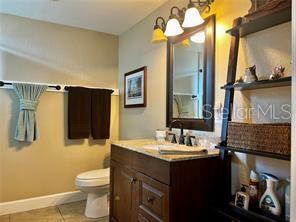16909 Franklin Avenue, Unit B Montverde, FL 34756 - Photo 9 of 13 a bathroom with a sink vanity and a mirror