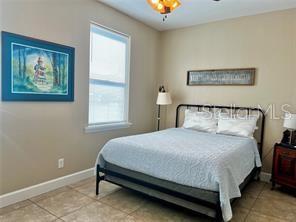 16909 Franklin Avenue, Unit B Montverde, FL 34756 - Photo 10 of 13 a bed sitting in a bedroom next to a window