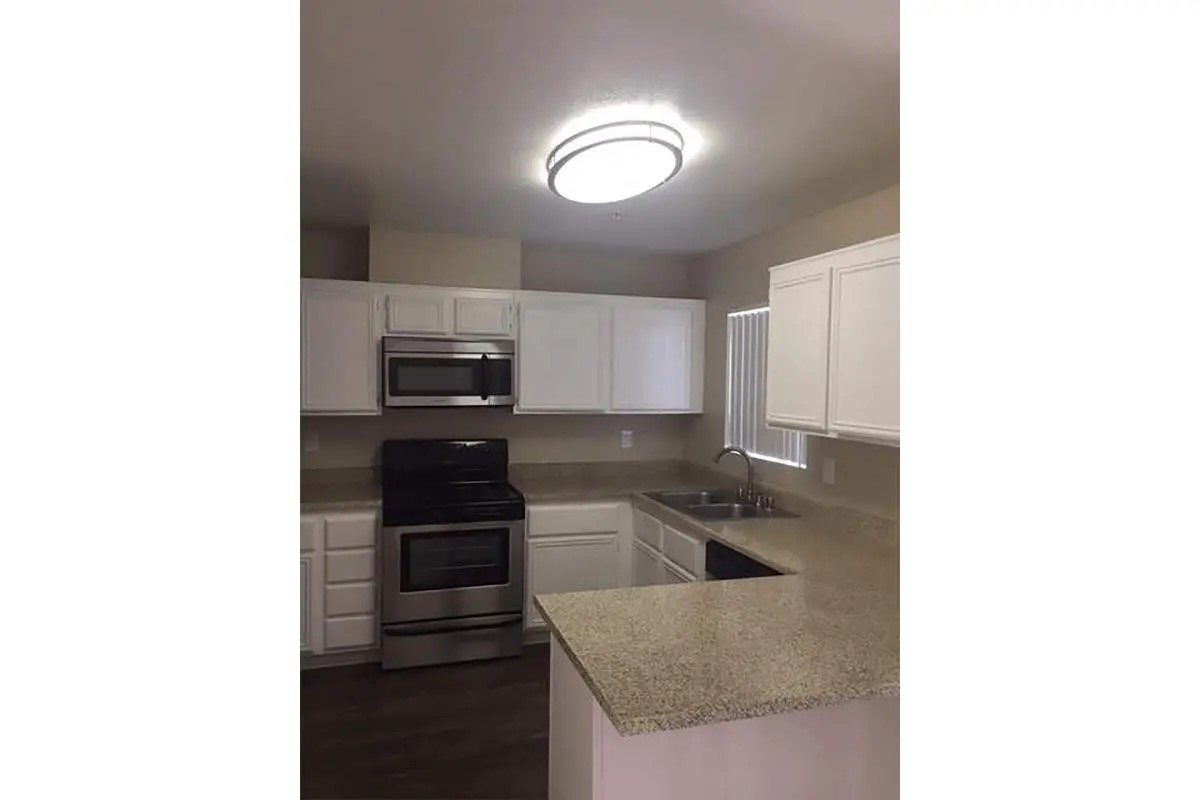392 East Stevens Road Palm Springs, CA 92262 - Photo 8 of 10 a kitchen with a sink cabinets and stainless steel appliances