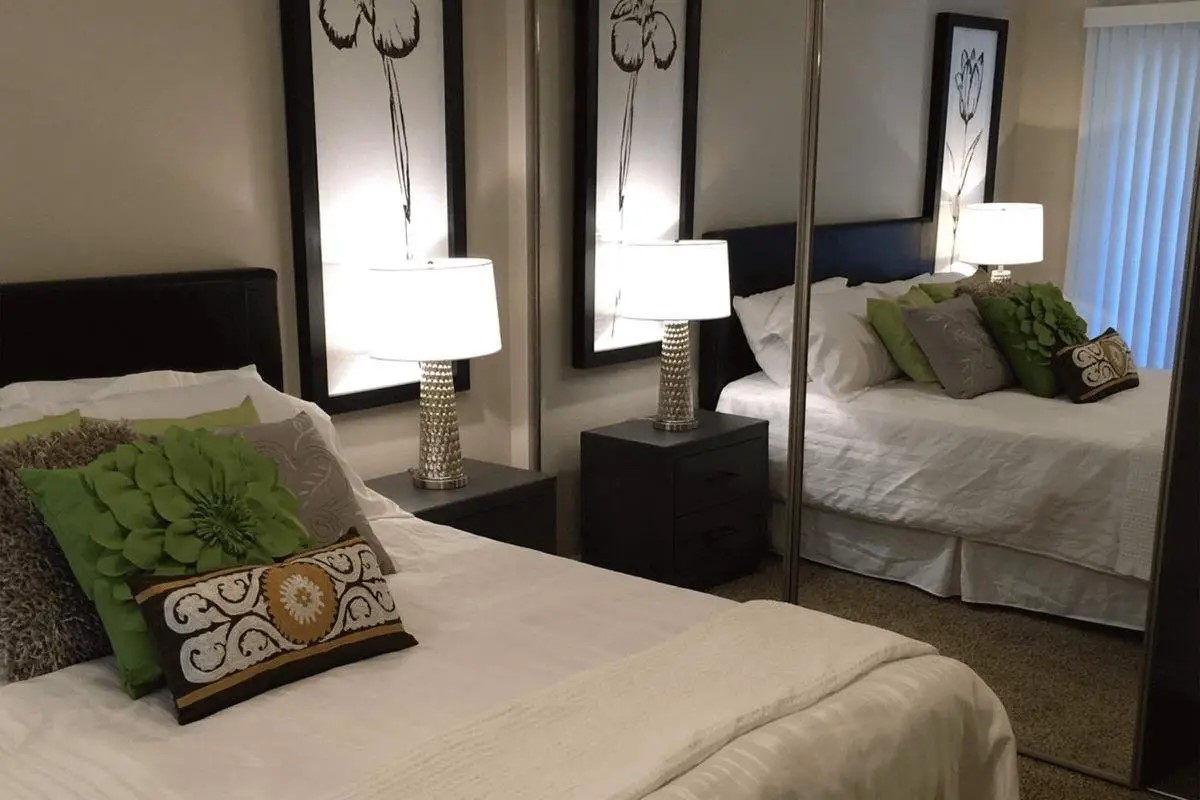 392 East Stevens Road Palm Springs, CA 92262 - Photo 9 of 10 a bedroom with a bed and a lamp