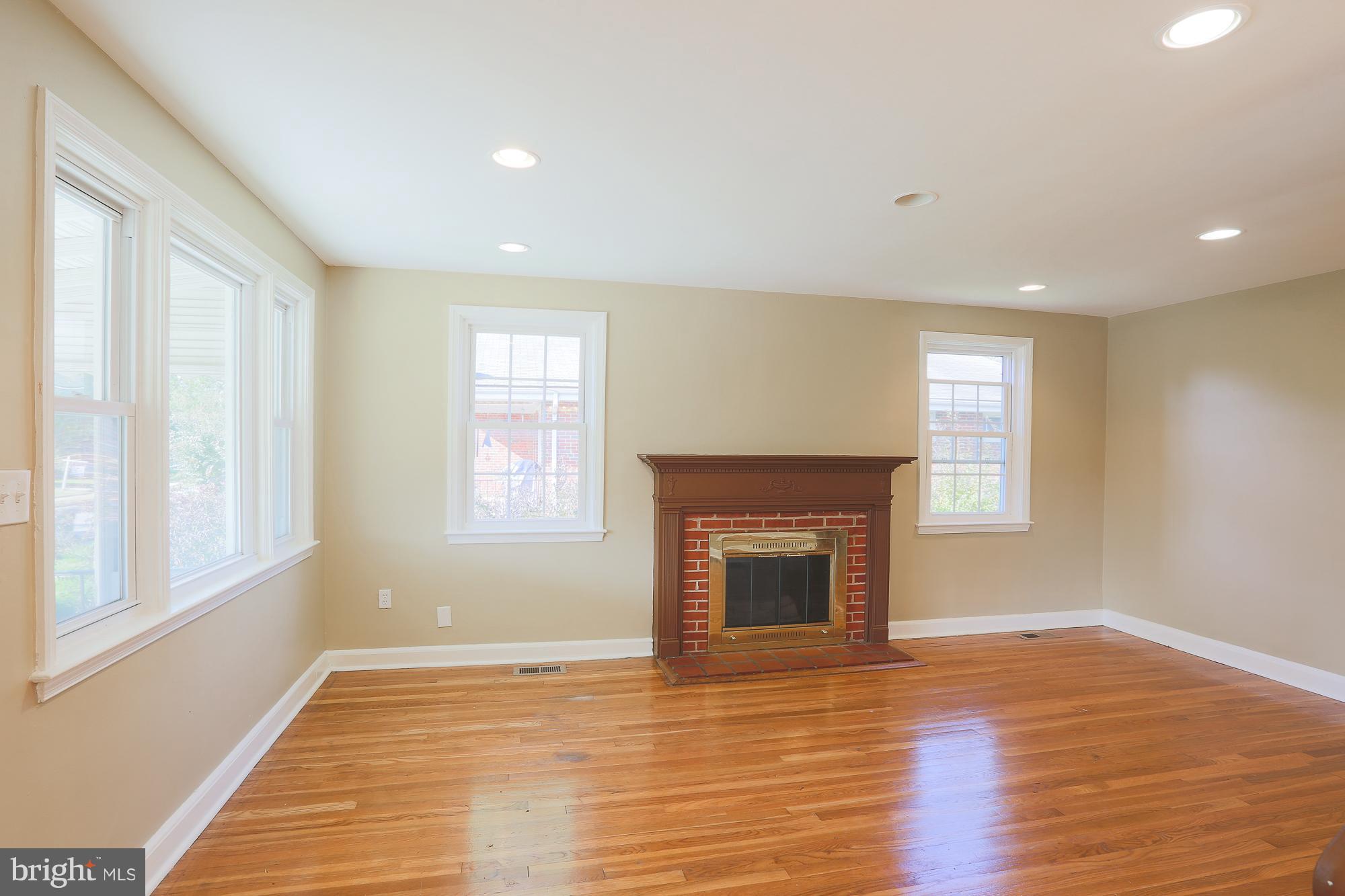 Living room with hardwood floors and fireplace