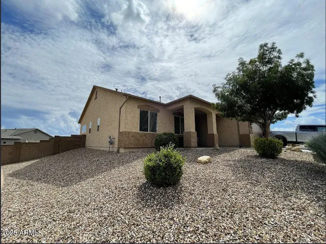 a front view of a house with a garden