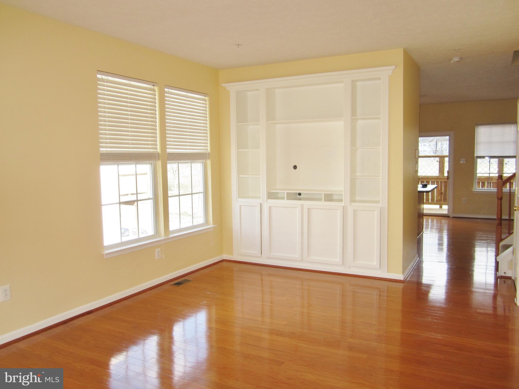 829 Lowe Road Baltimore, MD 21220 - Photo 7 of 28 a view of an empty room with wooden floor and a window