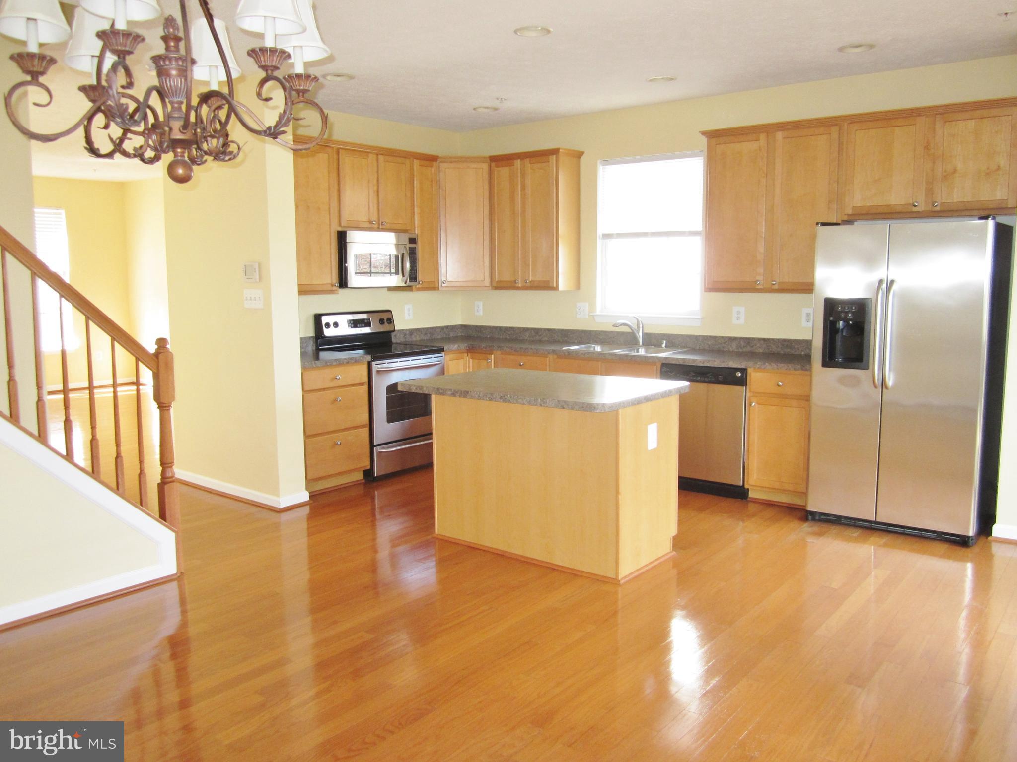 829 Lowe Road Baltimore, MD 21220 - Photo 8 of 28 a kitchen with stainless steel appliances granite countertop a stove a sink dishwasher and a refrigerator