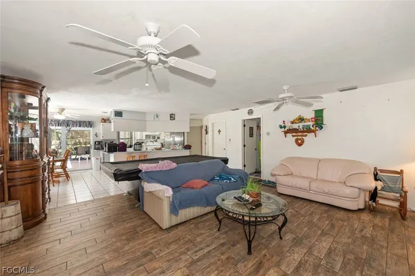 a living room with furniture and kitchen view