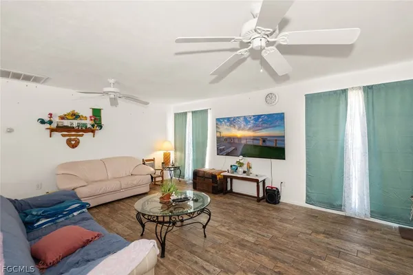 a living room with furniture and wooden floor