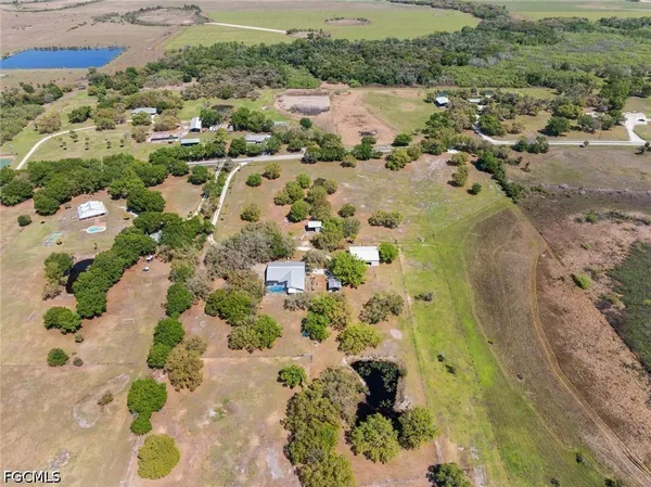 an aerial view of a house with a yard and lake view