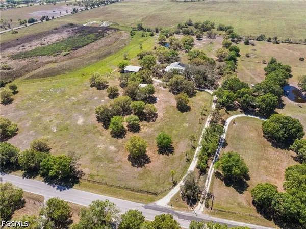 an aerial view of a residential houses with outdoor space