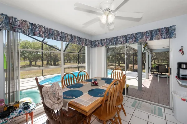 a dining room with furniture a chandelier and wooden floor