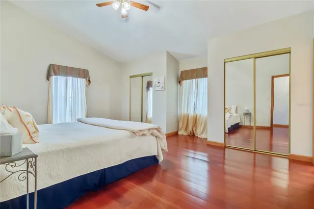 a spacious bedroom with a bed and a chandelier