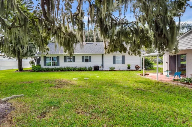 a front view of a house with a yard table and chairs