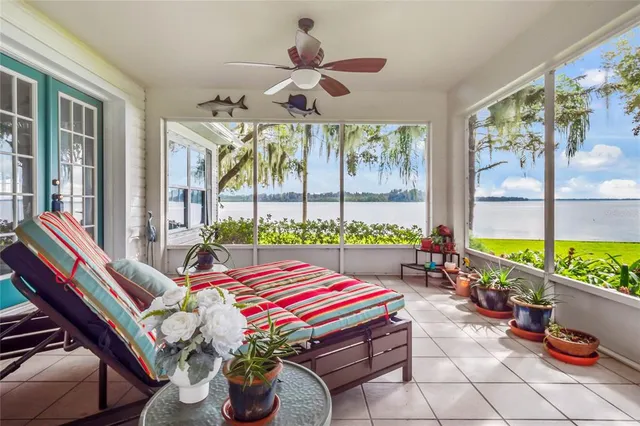 a living room with patio furniture and a large window