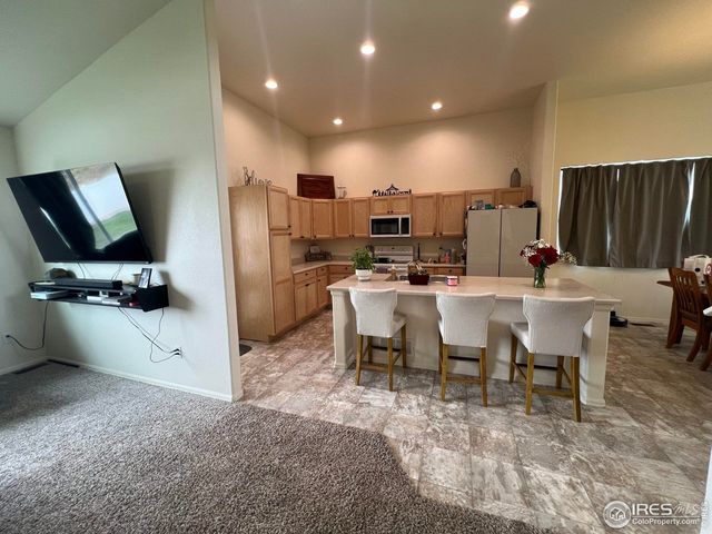 a kitchen with sink refrigerator and microwave