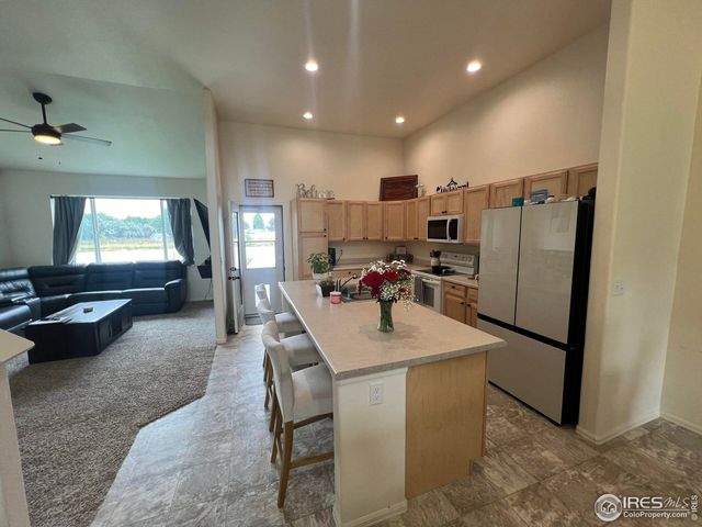 a kitchen with stainless steel appliances granite countertop sink refrigerator and stove