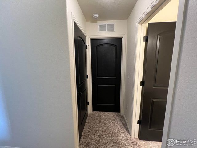 a view of hallway with wooden floor