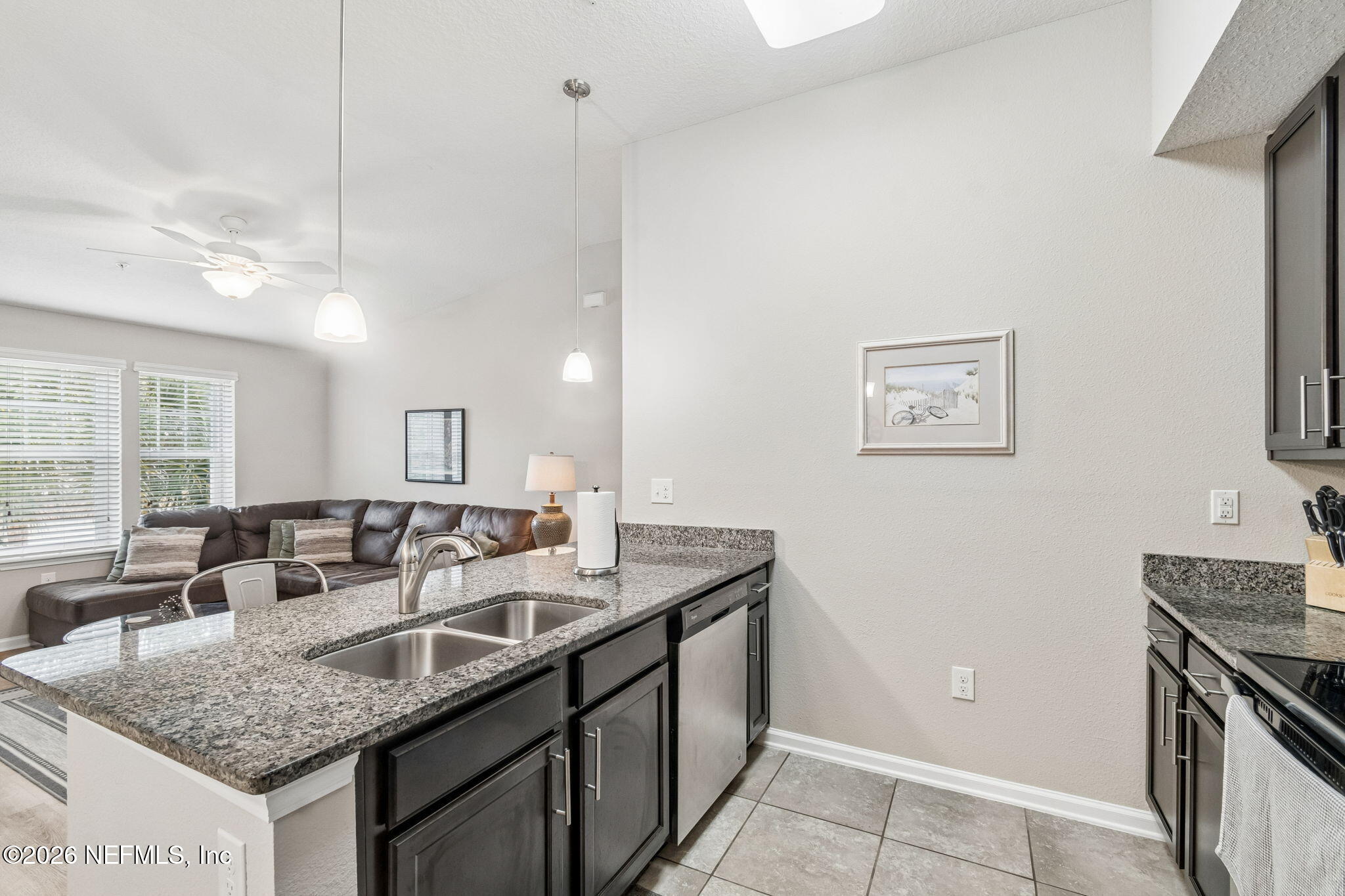 2113 Golden Lake Loop St. Augustine, FL 32084 - Photo 19 of 50 a kitchen with granite countertop a sink a counter top space and living room view