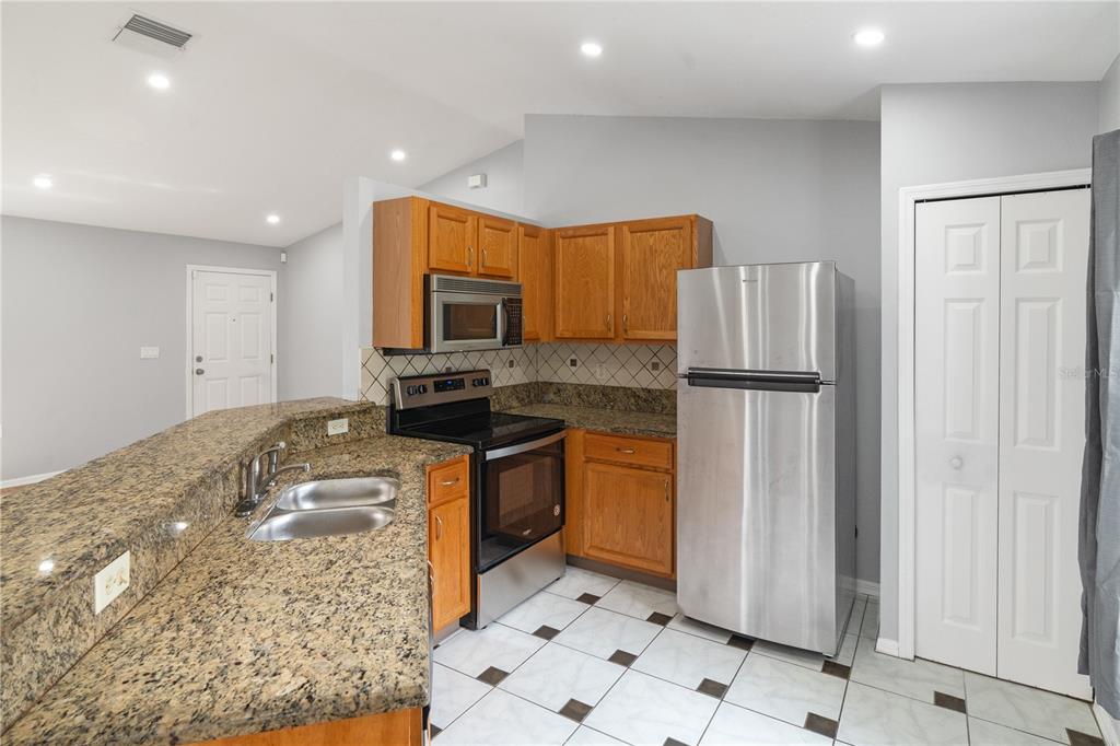 17168 Southwest 39th Circle Ocala, FL 34473 - Photo 11 of 36 a kitchen with stainless steel appliances granite countertop a refrigerator and a sink