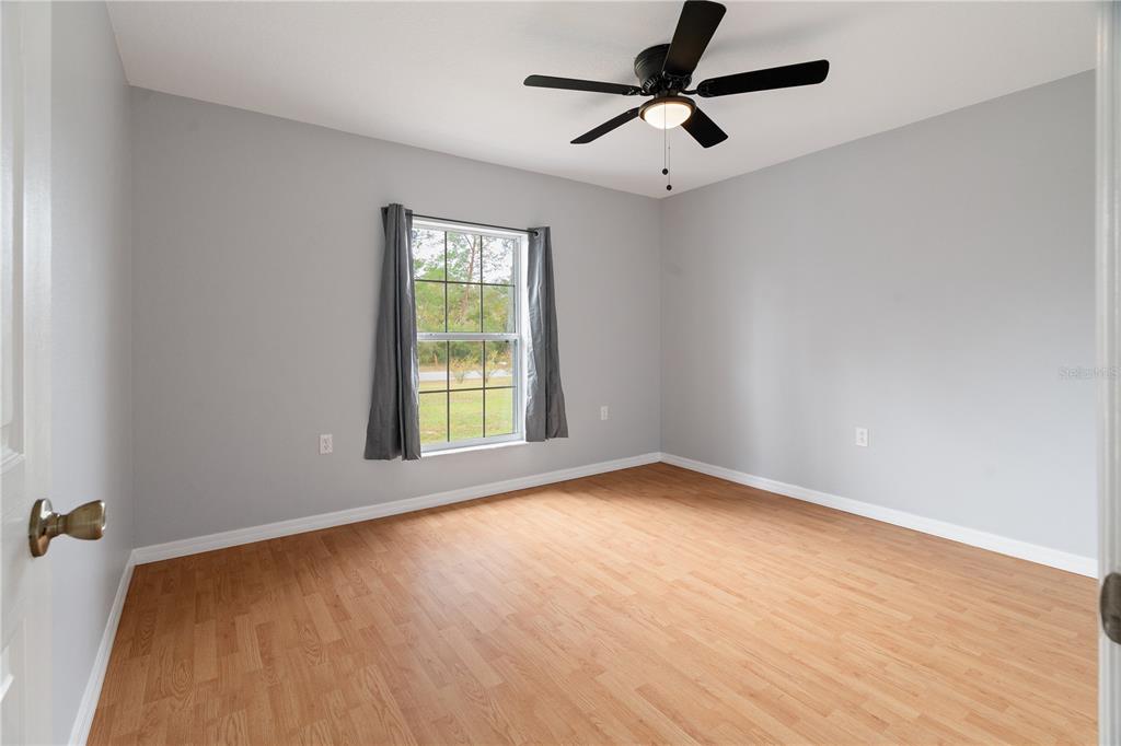 17168 Southwest 39th Circle Ocala, FL 34473 - Photo 23 of 36 wooden floor in an empty room with a window
