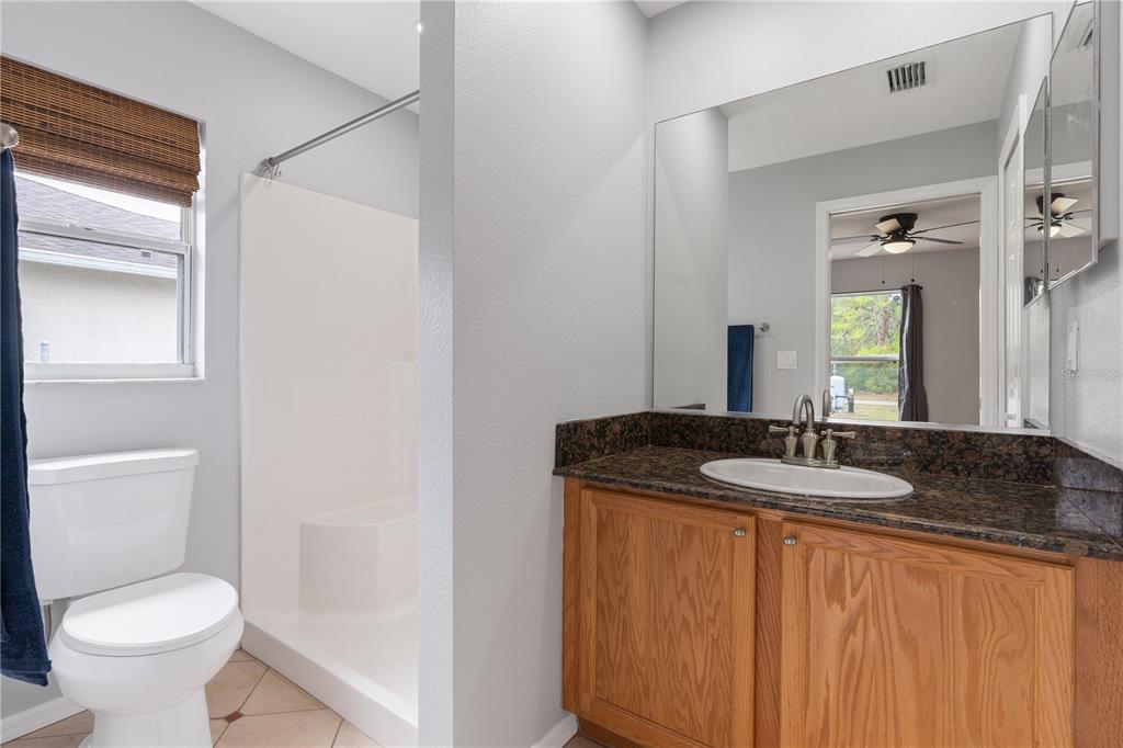 17168 Southwest 39th Circle Ocala, FL 34473 - Photo 27 of 36 a bathroom with a granite countertop sink and a toilet