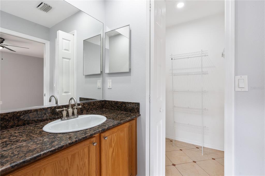 17168 Southwest 39th Circle Ocala, FL 34473 - Photo 30 of 36 a bathroom with a granite countertop sink and a mirror