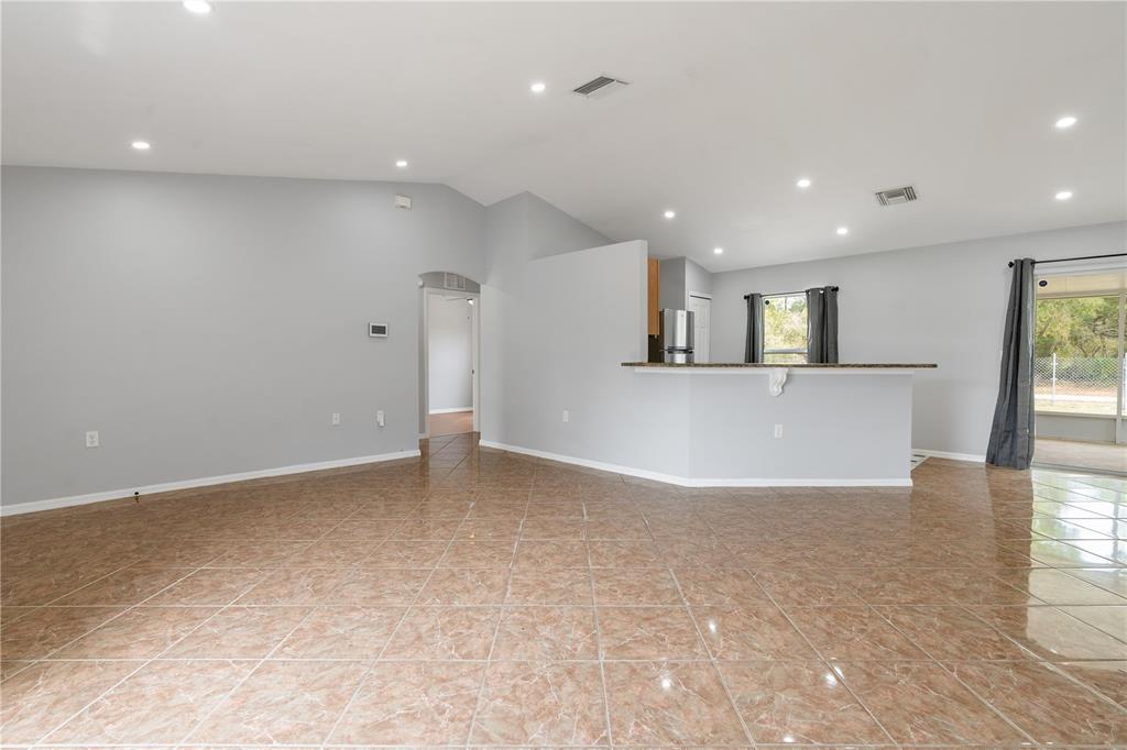 17168 Southwest 39th Circle Ocala, FL 34473 - Photo 5 of 36 an empty room with kitchen and window