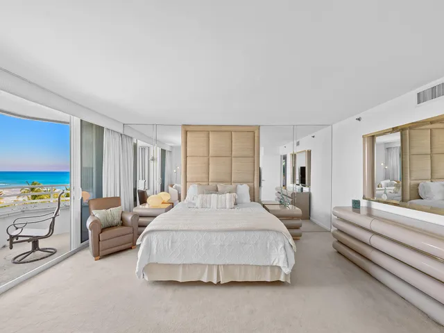 a spacious bedroom with a bed and large windows