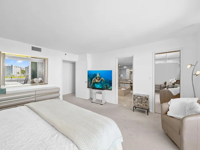 a bedroom with furniture and a flat screen tv