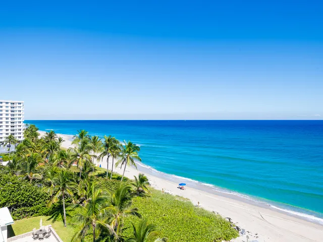 a living room with furniture and large windows