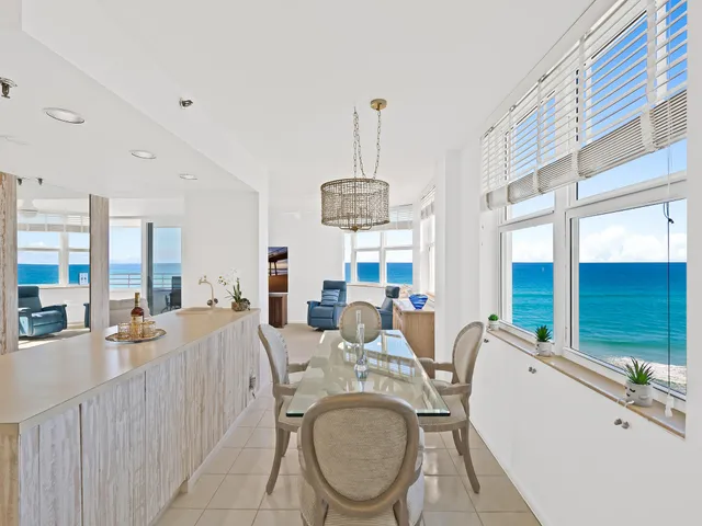 a room with gym equipment and large windows