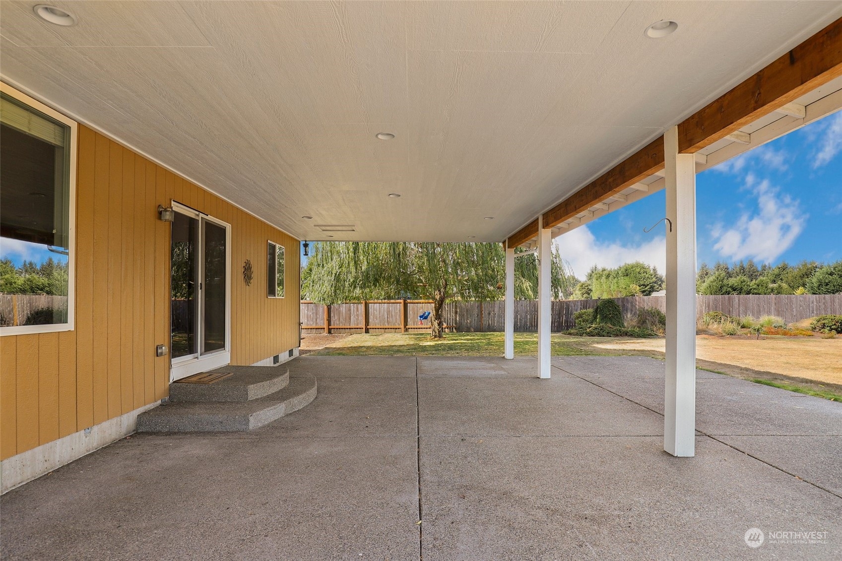 4633 181st Lane Southwest Rochester, WA 98579 - Photo 12 of 40 a view of an empty room with wooden floor and door