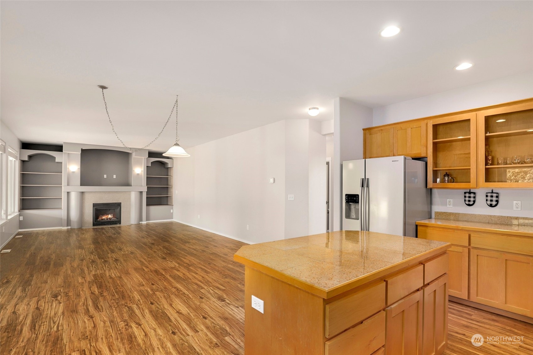 4633 181st Lane Southwest Rochester, WA 98579 - Photo 14 of 40 a kitchen with stainless steel appliances kitchen island granite countertop a refrigerator a stove and oven with wooden floor