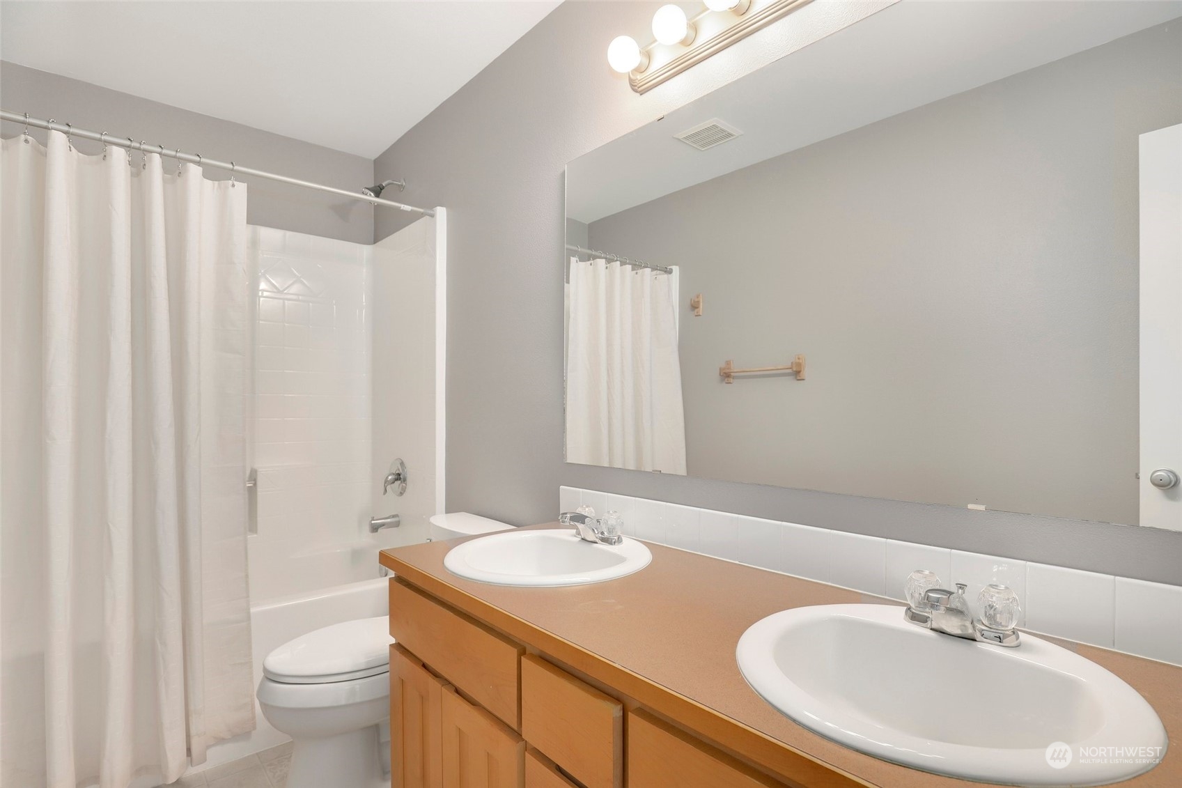 4633 181st Lane Southwest Rochester, WA 98579 - Photo 27 of 40 a bathroom with a granite countertop sink and a mirror