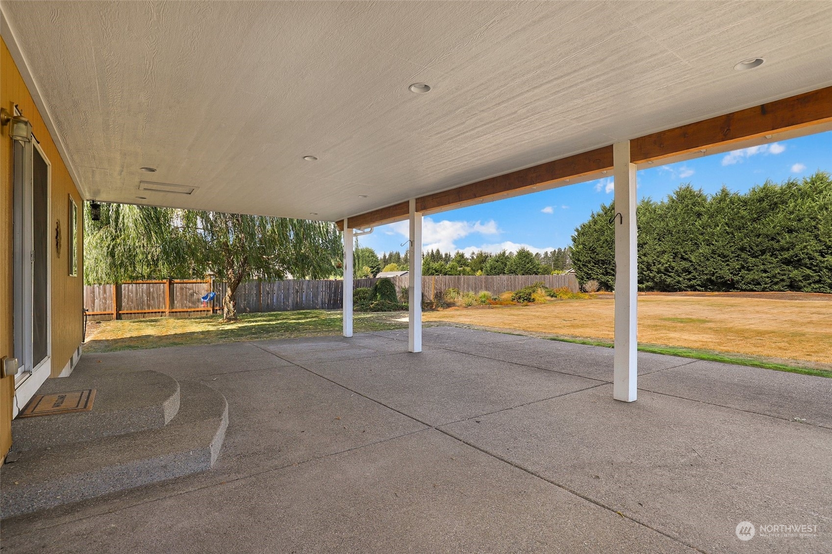 4633 181st Lane Southwest Rochester, WA 98579 - Photo 32 of 40 a view of an empty room with wooden floor and fence