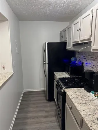 a kitchen with a stove and a refrigerator