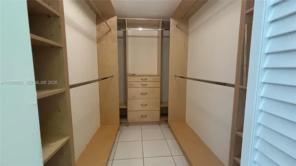 a view of walk in closet with empty racks
