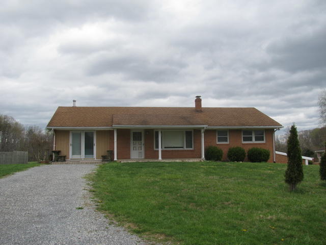 2668 Quarles Road Thaxton, VA 24174 - Photo 1 of 21 a front view of the house with a garden
