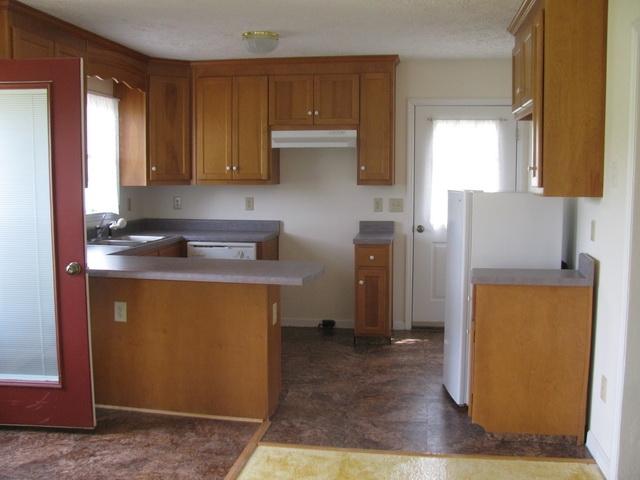 2668 Quarles Road Thaxton, VA 24174 - Photo 19 of 21 a kitchen with a refrigerator sink and cabinets