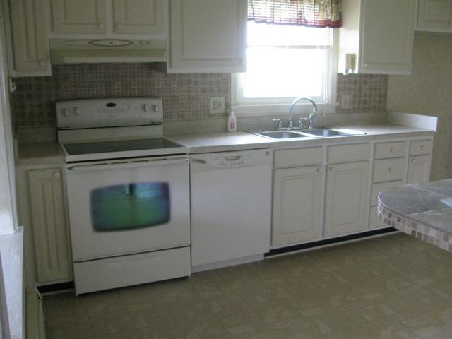 2668 Quarles Road Thaxton, VA 24174 - Photo 4 of 21 a kitchen with a sink stove and cabinets