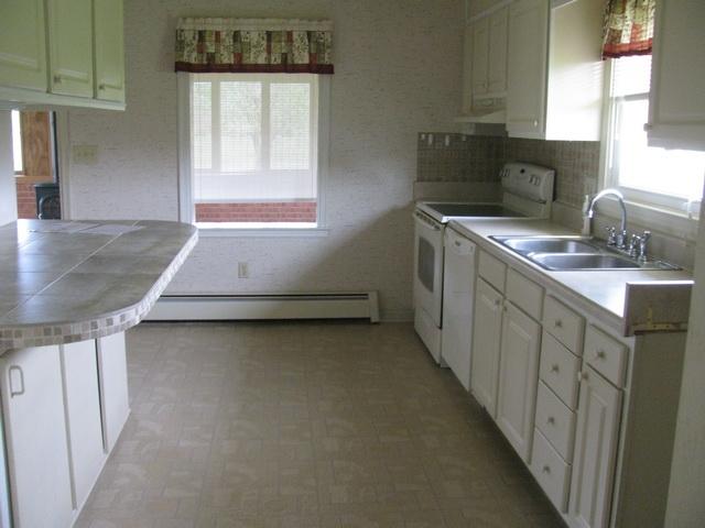 2668 Quarles Road Thaxton, VA 24174 - Photo 5 of 21 a kitchen with sink cabinets and window