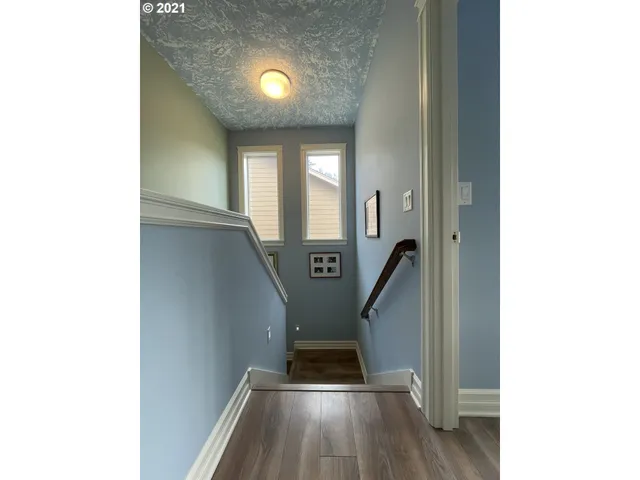 a view of entryway and hall with wooden floor