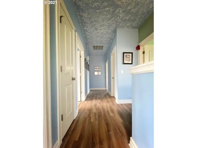 a view of hallway with wooden floor