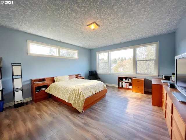 a spacious bedroom with a bed and a couch