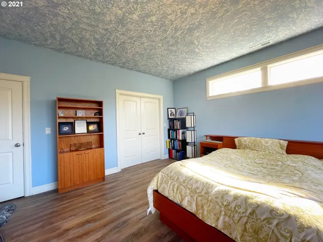 a bed sitting in a bedroom next to a window