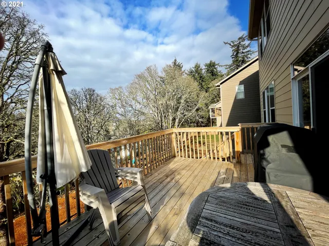 a view of balcony with wooden floor and fence