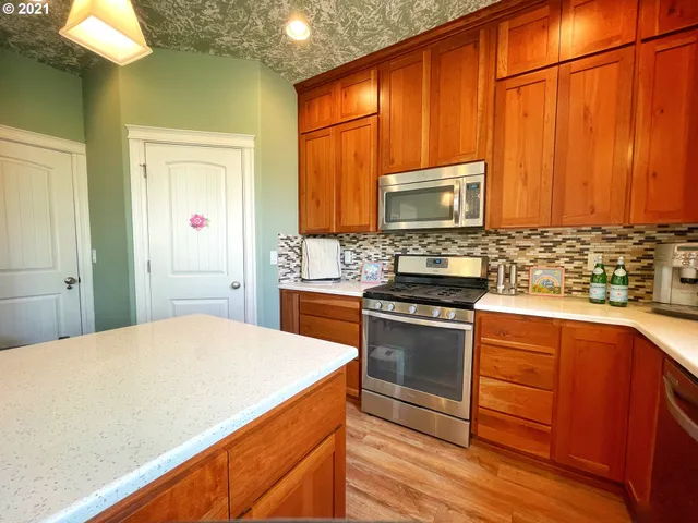 a kitchen with a stove a sink and a microwave