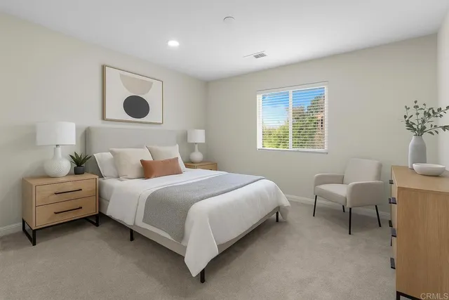 a bedroom with a bed and a chair