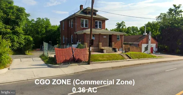 a view of a brick house with a yard