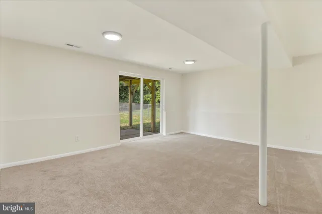 an empty room with yard and outdoor view