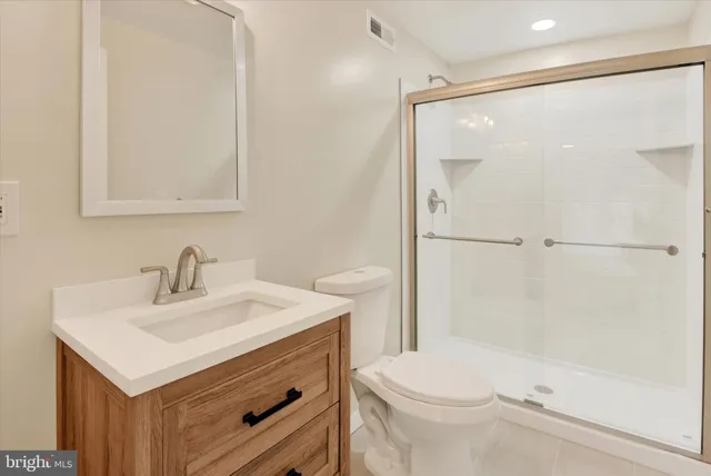 a bathroom with a sink mirror vanity and toilet