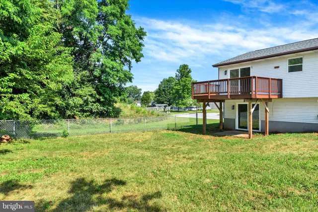 a view of house with backyard